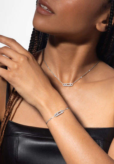 Messika Baby Move 18K White Gold Pavé Diamond Bracelet & Necklace on model with leather top