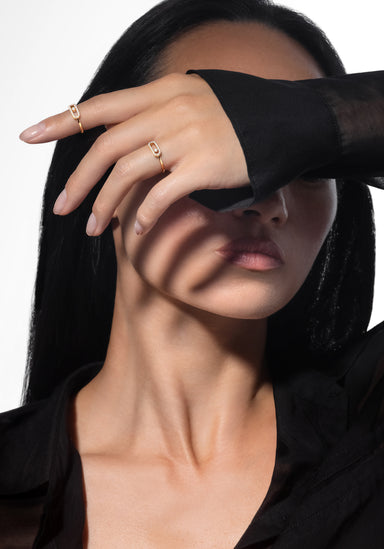 Brunette model wearing two Messika Move Uno Pavé 18KRG Diamond Rings on hand covering her eyes