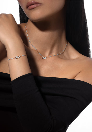 Model wearing Messika Move Uno Pavé 18K White Gold Diamond Necklace & Bracelet in black top