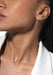 Closeup of Black model wearing a single Messika Move Uno 18K Gold Diamond Earring and white blazer