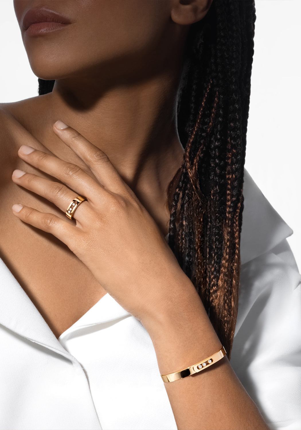 Black model with dreads in white shirt with Messika Move Noa 18K Yellow Gold Diamond Bangle and ring