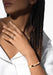 Black model with dreads in white shirt with Messika Move Noa 18K Yellow Gold Diamond Bangle and ring