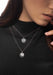 Closeup of brunette model wearing Messika Lucky Move PM Pavé Diamond 18KWG Necklace and a black top