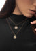 Closeup of brunette model wearing Messika Lucky Move PM Pavé Diamond 18KYG Necklace and a black top