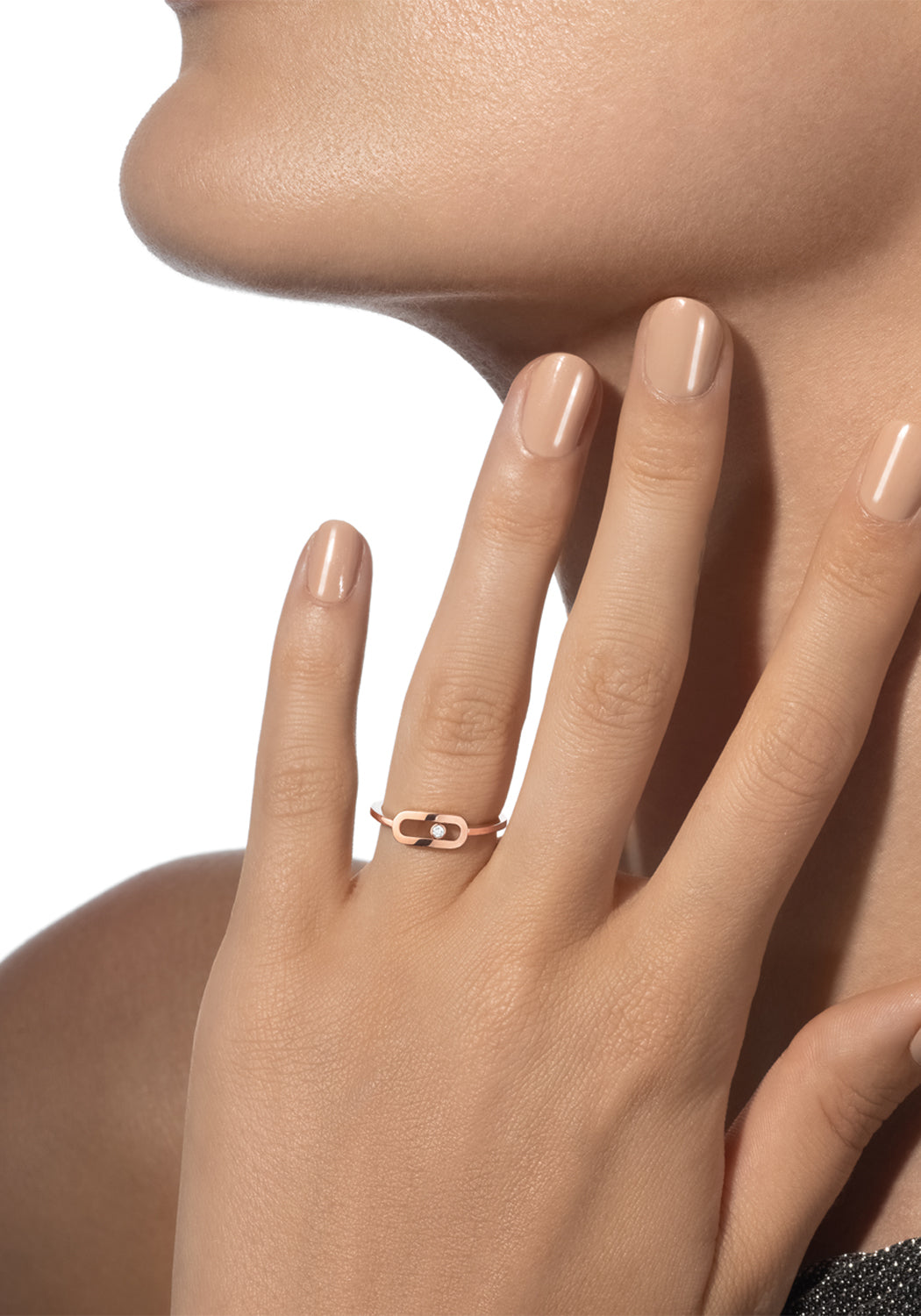 Closeup of a model with hand near face wearing a Messika Move Uno Smooth 18K White Gold Diamond Ring