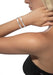 Messika Move Noa SM 18KWG Pavé Diamond Bangle on a blonde model's wrist wearing a vinyl tube top