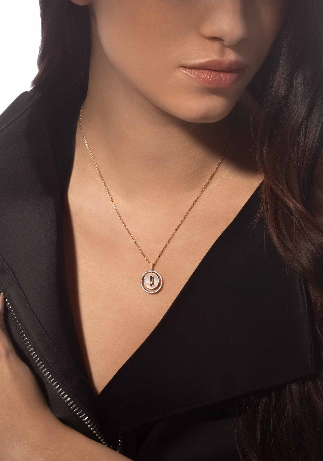 Brunette model wearing a Messika Lucky Move PM MOP 18KRG Diamond Necklace with a black v-neck blouse