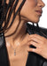 Closeup of Messika Move Uno Pavé LM 18KWG Diamond Necklace on a Black model in a black blazer