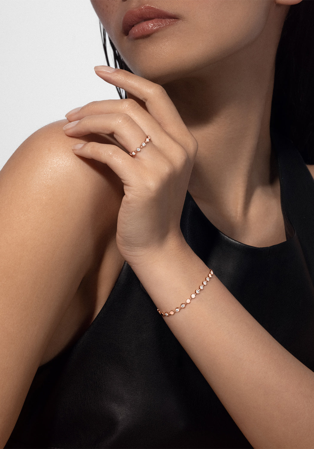 Brunette model wearing a Messika D-Vibes 18KRG Small Bezel Diamond Bracelet and ring (sold separate)
