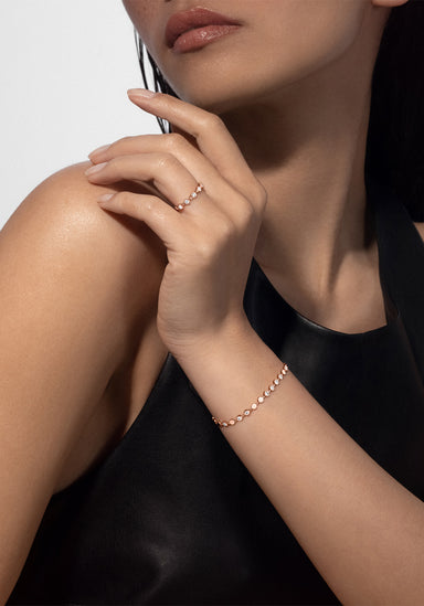 Brunette model wearing a Messika D-Vibes 18KRG Small Bezel Diamond Bracelet and ring (sold separate)