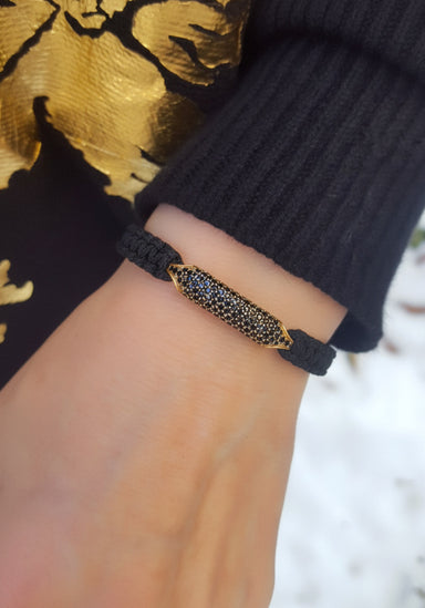 Woman wearing black slide cord, black diamond bracelet from Osterjewelers.com
