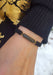 Woman wearing black slide cord, black diamond bracelet from Osterjewelers.com