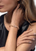 Messika Move Uno 18KYG Pavé Multi Diamond Bracelet on wrist of blonde model with a black tanktop