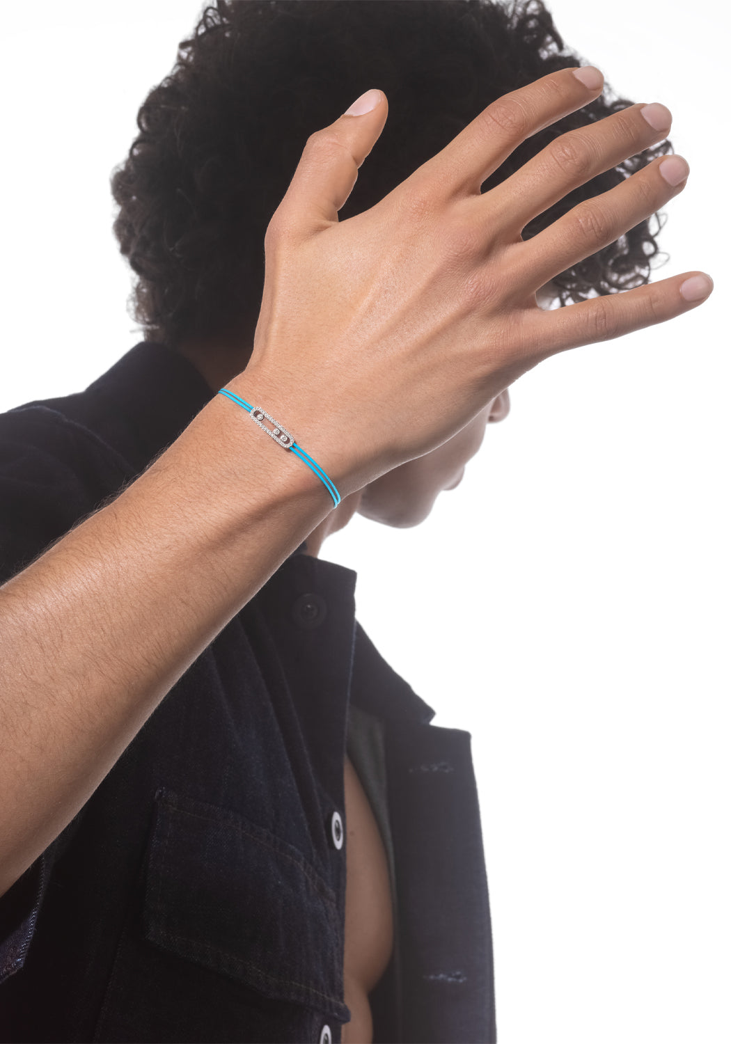 Messika Care(s) Blue Cord Pavé Diamond Bracelet on a tan curly haired brunette male model's wrist