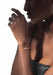 Closeup of Black model wearing a Messika Care(s) Orange Cord Diamond Bracelet and leather top