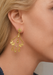Blonde Woman wearing ornate gold scroll baroque style chandelier earring.
