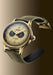 The Angelus Chronographe Tachymètre Yellow Gold shows it floating on a gradient background