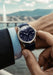 Czapek & Cie Quai des Bergues Midnight in Geneva on a man's wrist in front of Jet d'Eau de Genève