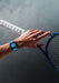 The Gerald Charles Maestro GC Sport Tennis Light Turquoise on a man's wrist holding a tennis racket
