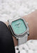 Gerald Charles Maestro 2.0 Ultra-Thin Jade shown on a wrist with with a white pebble background.