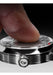 Close up of a finger touching the face of the SB 10 Jumping Hour Meteorite watch.