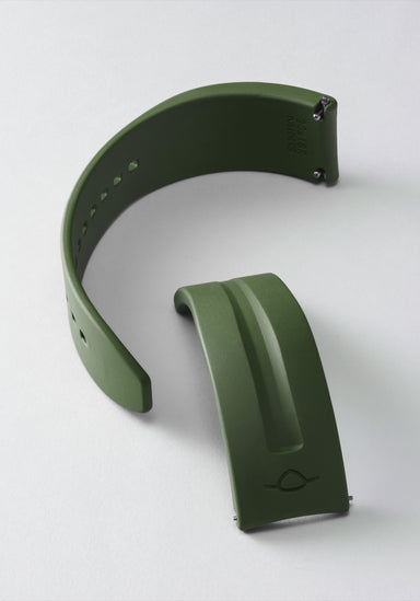 The MING FKM Forest Green Rubber Strap shown on its side in two pieces on a light background.