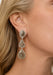Blonde woman wearing oval, oblong and triaangular shaped grey diamond dangle earring.