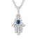 A closeup of the MO & ME 14KWG Diamond & Sapphire Mini Hamsa Necklace on a white background