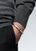 Messika Moderniste 18KRG Large Pavé Diamond Bangle on the wrist of a male model in a dark sweater