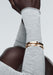 Messika Moderniste 18KRG Large Pavé Diamond Bangle on the wrist of a Black model in a grey sweater