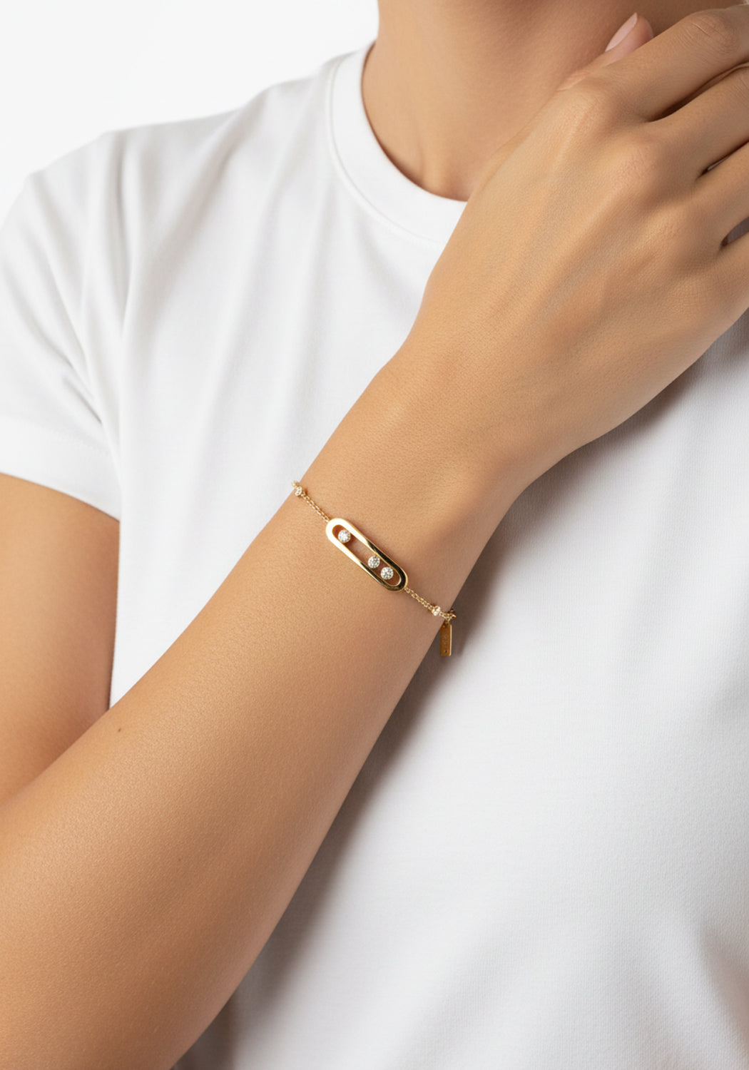 Messika Baby Move 18K Yellow Gold Diamond Bracelet shown on model's wrist wearing a white t-shirt.