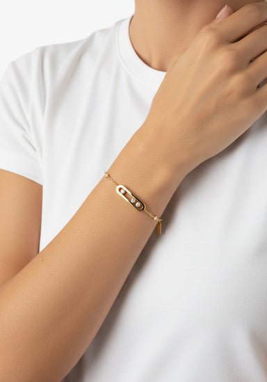Messika Baby Move 18K Yellow Gold Diamond Bracelet shown on model's wrist wearing a white t-shirt.