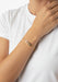 Messika Baby Move 18K Yellow Gold Diamond Bracelet shown on model's wrist wearing a white t-shirt.