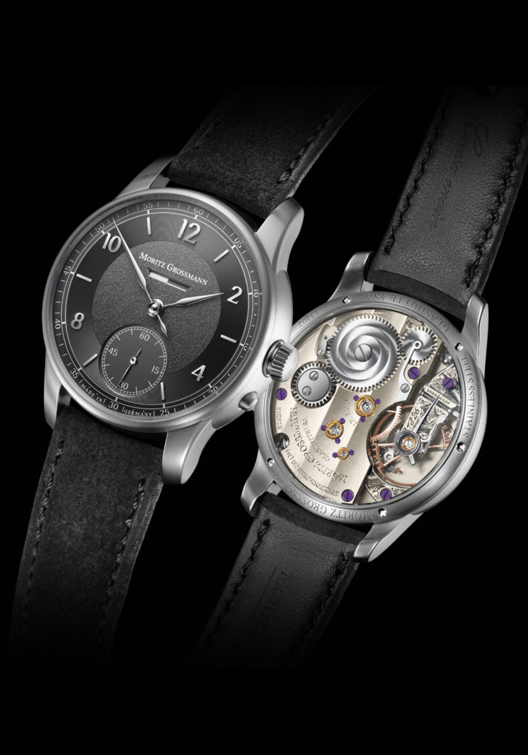 Front & back of the Moritz Grossmann Benu Power Reserve Black Stainless Steel on a black background