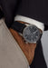 Moritz Grossmann Benu Power Reserve Black Stainless Steel on a man's wrist with hand in his pocket