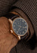 The Moritz Grossmann Hamatic Enamel Rose Gold on a man's wrist wearing a brown suit