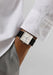 The clean white dial of the NOMOS Tetra 27 White Stainless Steel Watch pops on a man's wrist