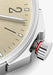 A closeup of the NOMOS Ahoi Neomatik Sand screw-down crown featuring a red warning ring.