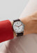 The clean dial of the NOMOS Club 38 flatters every gender. Shown on a woman's wrist.