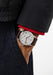 The clean dial of the NOMOS Club 38 flatters every gender. Shown on a man's wrist.
