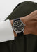 The clean dial of the NOMOS Club 38 flatters every gender. Shown on a man's wrist.