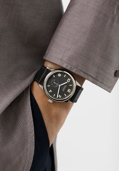The clean dial of the NOMOS Club 38 flatters every gender. Shown on a woman's wrist.