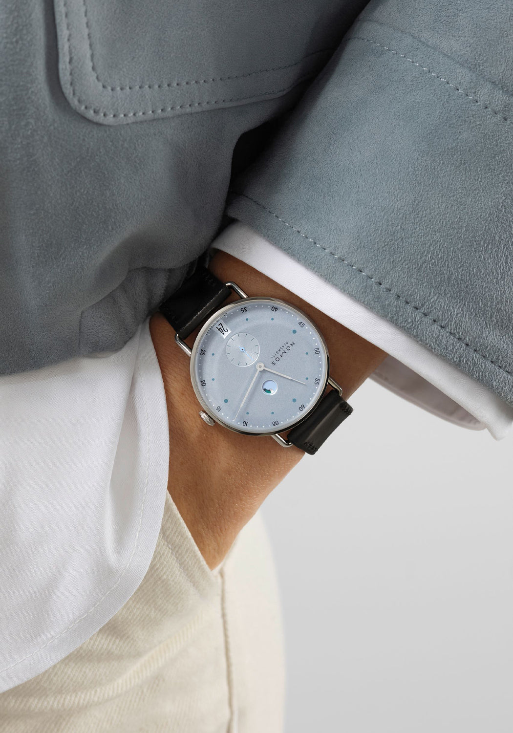 NOMOS Metro Date Power Reserve Ice Blue on a man's wrist | Denver Watches | OsterJewelers.com