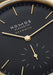 Closeup of the minimalist NOMOS Orion Gold Neomatik New Black dial showing the gold indexes & hands
