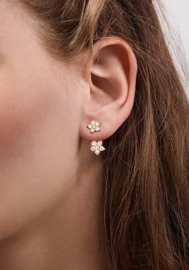 Model wearing an Ole Lynggaard Diamond Star Stud with a Star Earring Pendant. (Sold Separately)