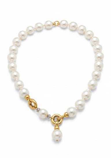 A pearl necklace with a gold clasp and pendant, featuring diamond accents around one pearl, shown on a plain white background.
