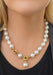 Large Pearl necklace with a gold clasp worn by blonde woman