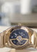 The glass caseback reveals openworked bridges with a skeletonized 22k rose gold oscillating weight.
