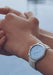 The Parmigiani Fleurier Toric Petite Seconde Morning Blue on a man's wrist shows the striking dial
