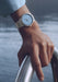 The Parmigiani Fleurier Toric Petite Seconde Morning Blue on a man's wrist by water | Denver Watches